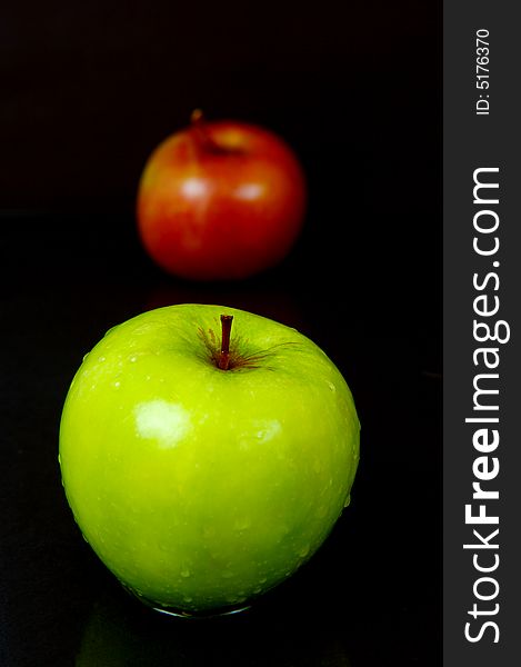 Red & green apples isolated against a black background