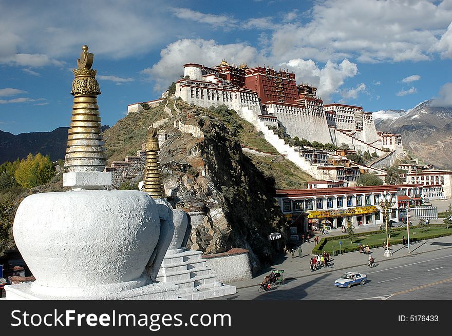 The dagobas of a Lama temple and the Potala Palace on the potala mountain, under the blue sky and white clouds. The dagobas of a Lama temple and the Potala Palace on the potala mountain, under the blue sky and white clouds.