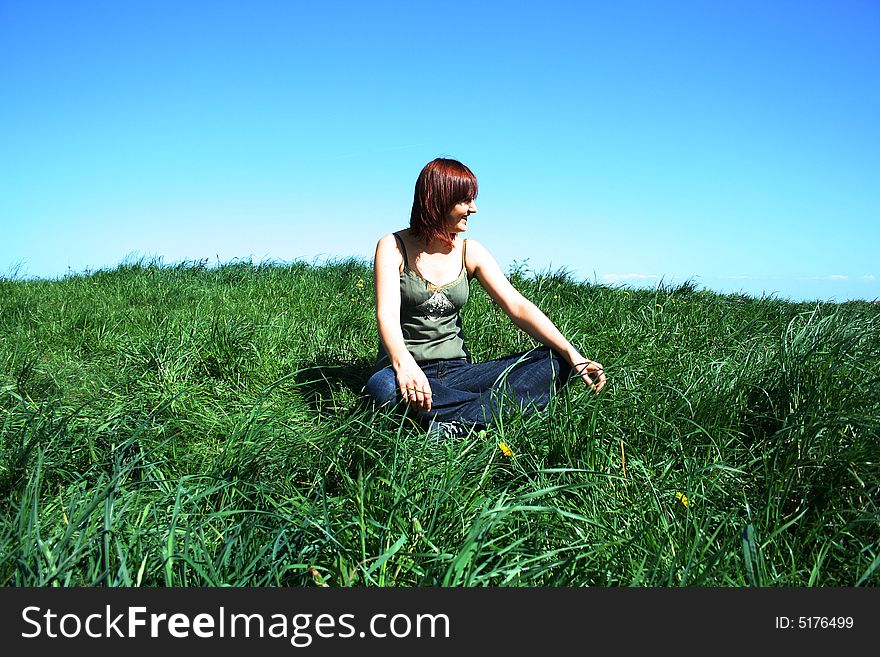 Young girl sittin on the grass. Young girl sittin on the grass