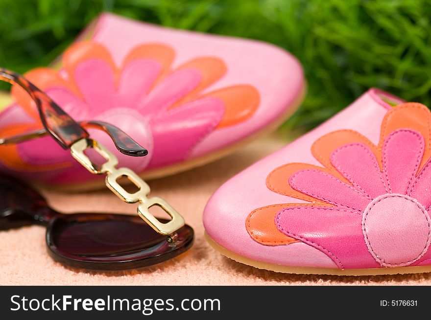 Summer shoes and sunglasses on towel and grass. Summer shoes and sunglasses on towel and grass