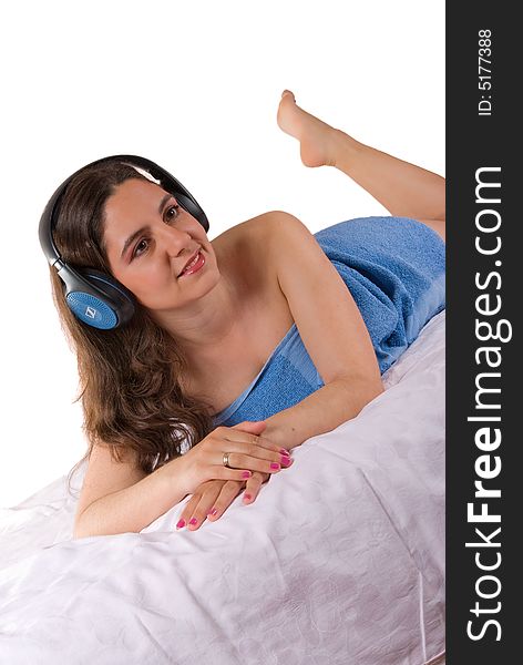 Beautiful girl in blue towel with headphones