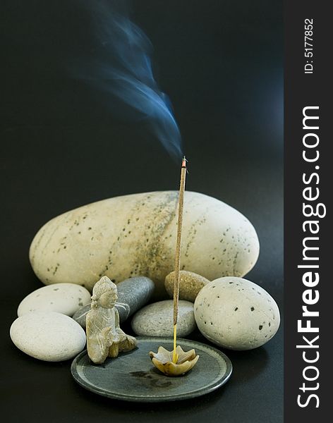 Incense stick and stones for a quiet meditation. Incense stick and stones for a quiet meditation