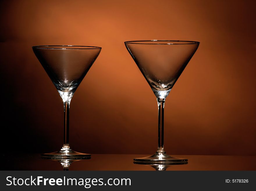A two wine glasses on the orange background