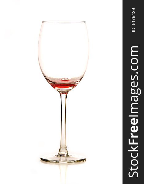 A stemmed wine glass with wine on a white background