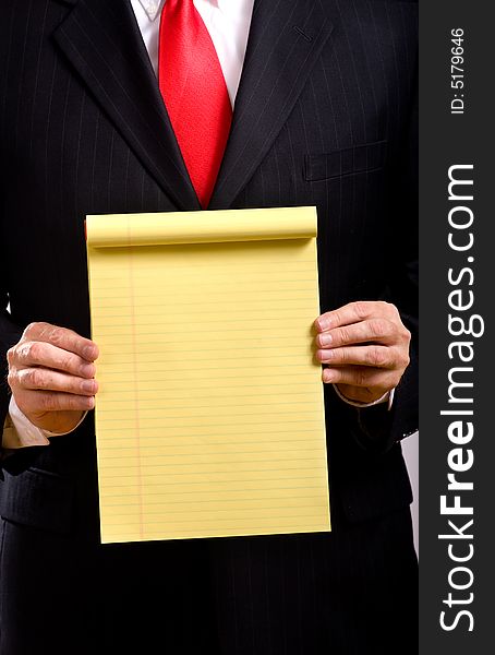 A business man in a blue suit and a red necktie holding a yellow tablet add your own copy or text, business communications. A business man in a blue suit and a red necktie holding a yellow tablet add your own copy or text, business communications