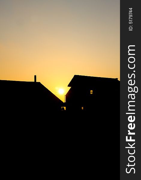 Sunset silhouette of two houses. Sunset silhouette of two houses