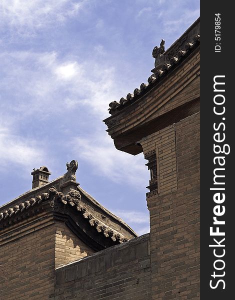 The high wall and old residence. Exquisite roof is ornamental. This ancient residence has already had a history of several hundred years. The high wall and old residence. Exquisite roof is ornamental. This ancient residence has already had a history of several hundred years.