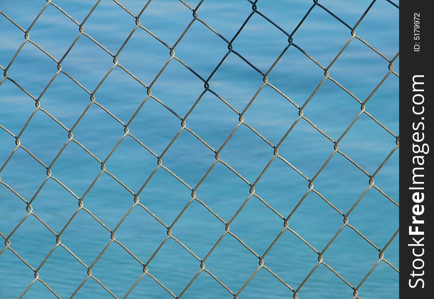 Steel net  with blue sea in background