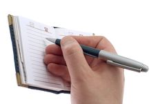 Hand Writes In A Notebook Royalty Free Stock Image
