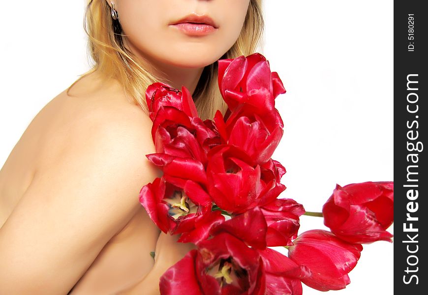 Sensual part of woman's body holding tulips on white
