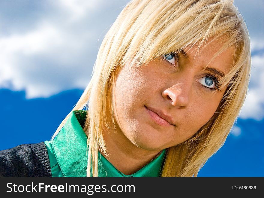 Cute blonde with blue eyes. Portrait on sky background. Cute blonde with blue eyes. Portrait on sky background.