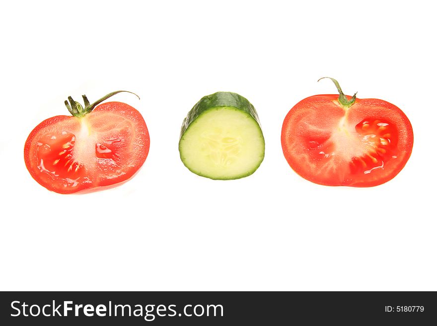 Cut tomatoes and cucumber isolated on a white background. Cut tomatoes and cucumber isolated on a white background