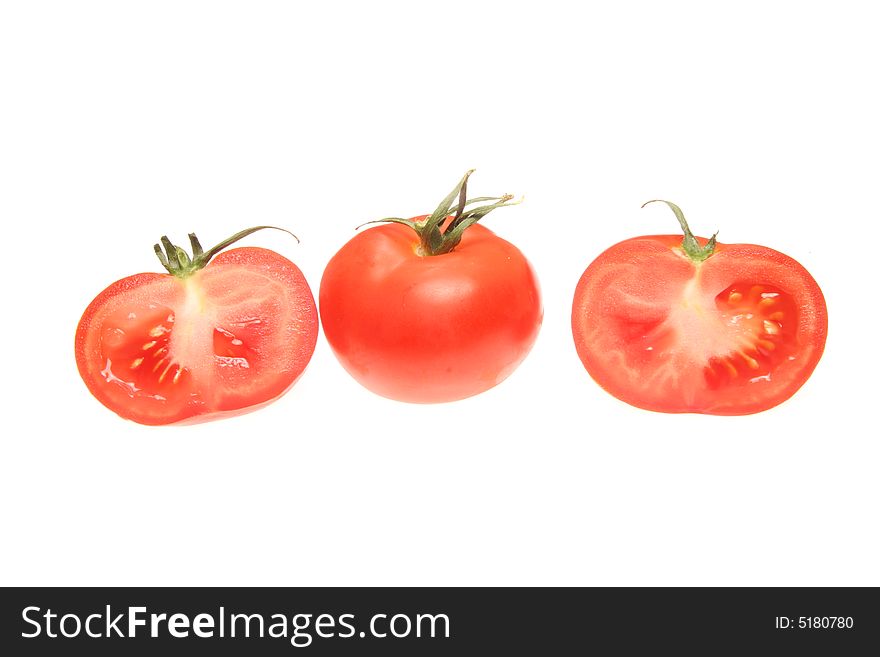 Cut and whole tomatoes isolated on a white background
