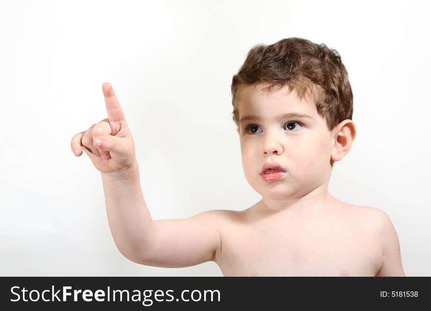 3 year old boy is pointing up and to the left. Hand in focus, face slightly out of focus. 3 year old boy is pointing up and to the left. Hand in focus, face slightly out of focus.