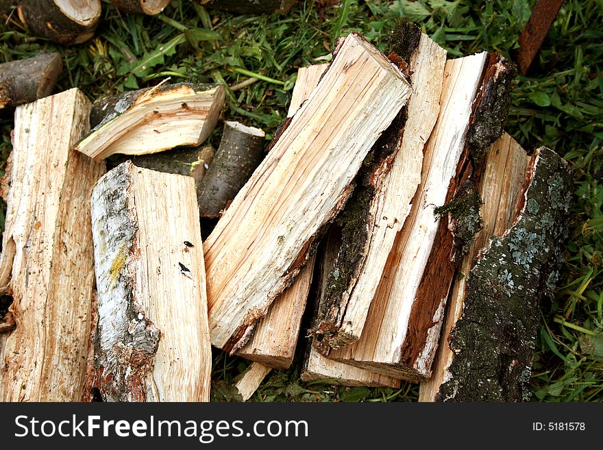 Firewood lay on a grass
