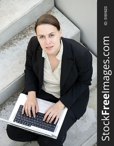 A business woman logging in in an outdoor environment