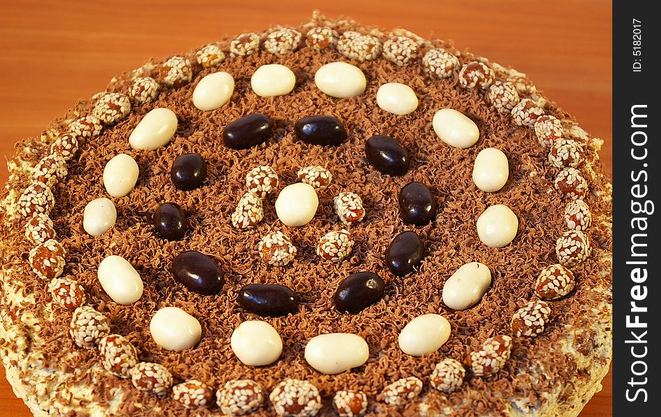 The celebratory ornate chocolate cake on a table