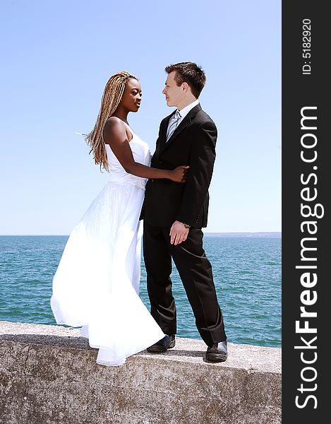 An young married couple on a photo shoot at the Hamilton harbor standing
on a concrete wall with the lake Ontario in the background. An young married couple on a photo shoot at the Hamilton harbor standing
on a concrete wall with the lake Ontario in the background.