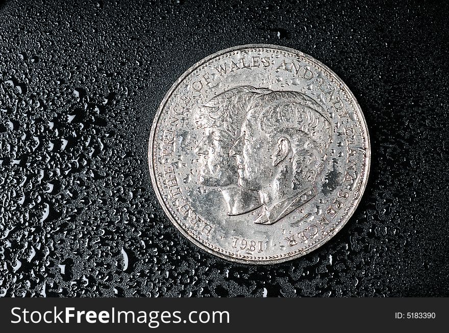 A view with a coins on a wet black background