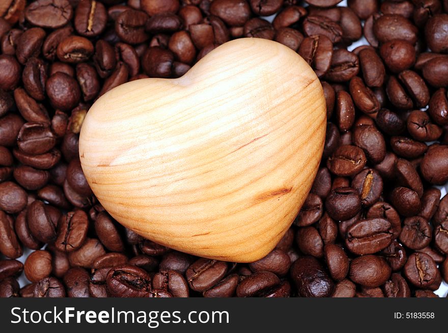 A view with coffee beans and wood heart. A view with coffee beans and wood heart