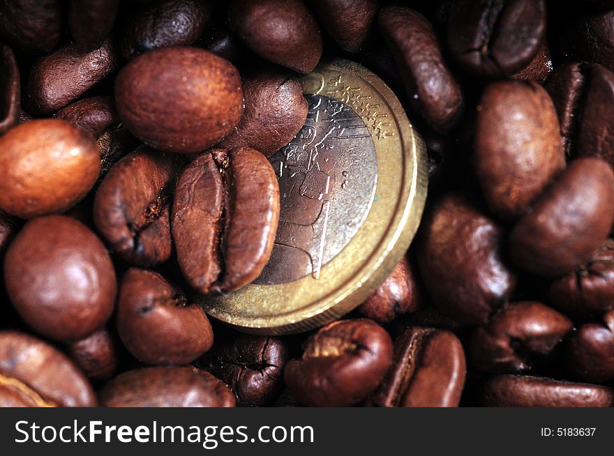 A view with coffee beans and euro coins. A view with coffee beans and euro coins