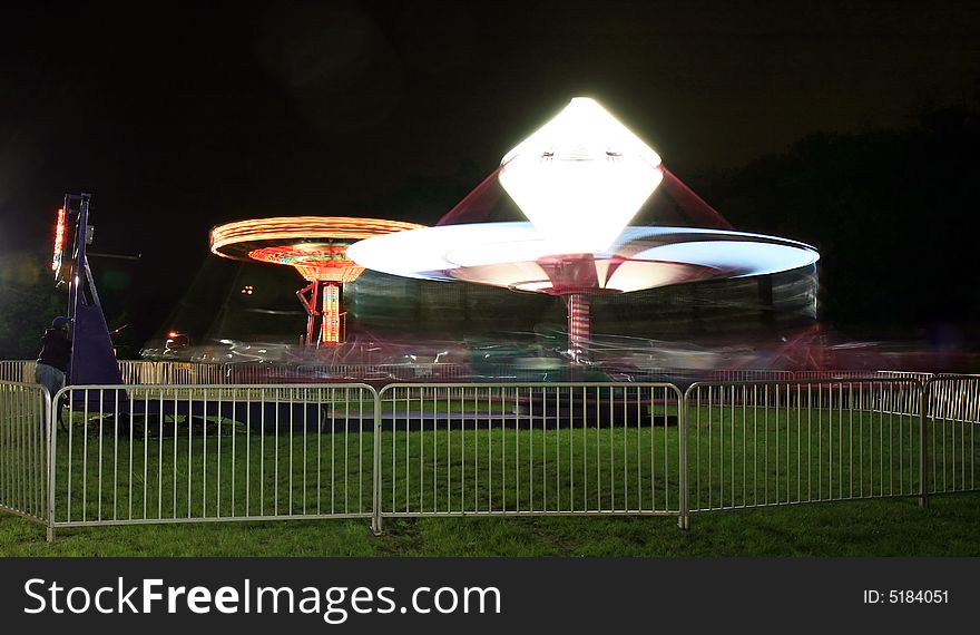 Outdoor amusement rides at night.