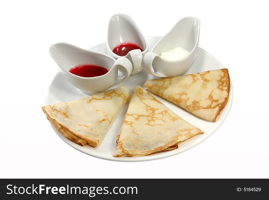 Pancakes on a white dish with sauce. Pancakes on a white dish with sauce