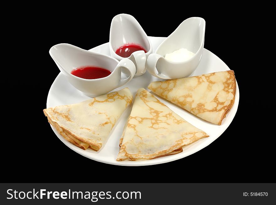 Pancakes on a white dish with sauce. Pancakes on a white dish with sauce