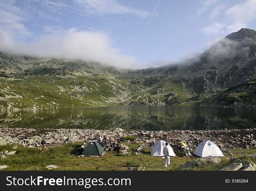 Mountain landscape with tent camp on the morning time