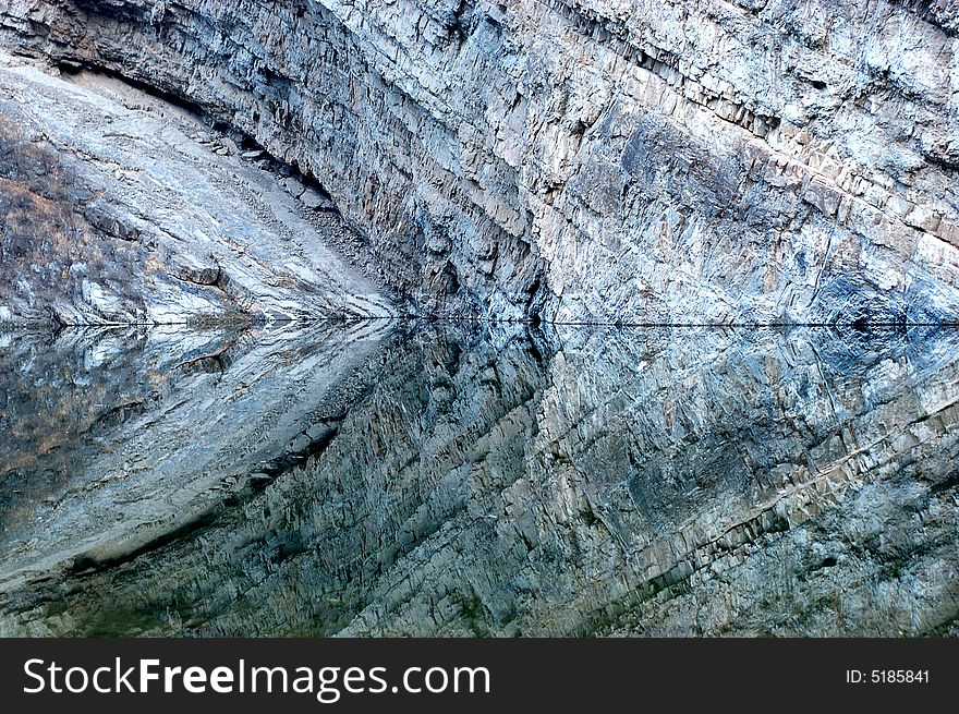 The texture of rock reflected in an quiet water surface. The texture of rock reflected in an quiet water surface.