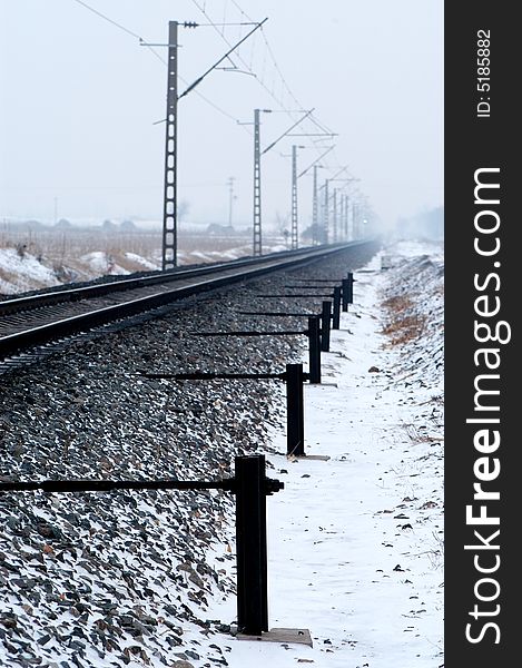 Railway spread out far beyond the horizon on the snow covered land. Railway spread out far beyond the horizon on the snow covered land.