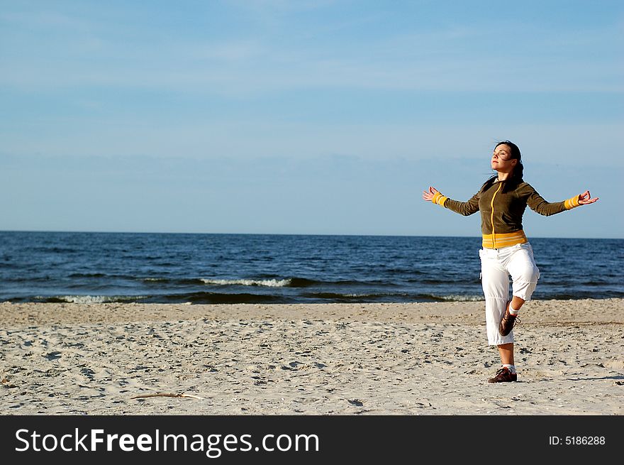 Attractive woman doing exercise on the beach. Attractive woman doing exercise on the beach