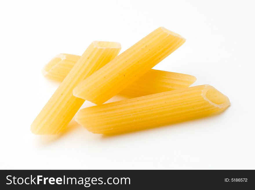 Yellow penne on white background