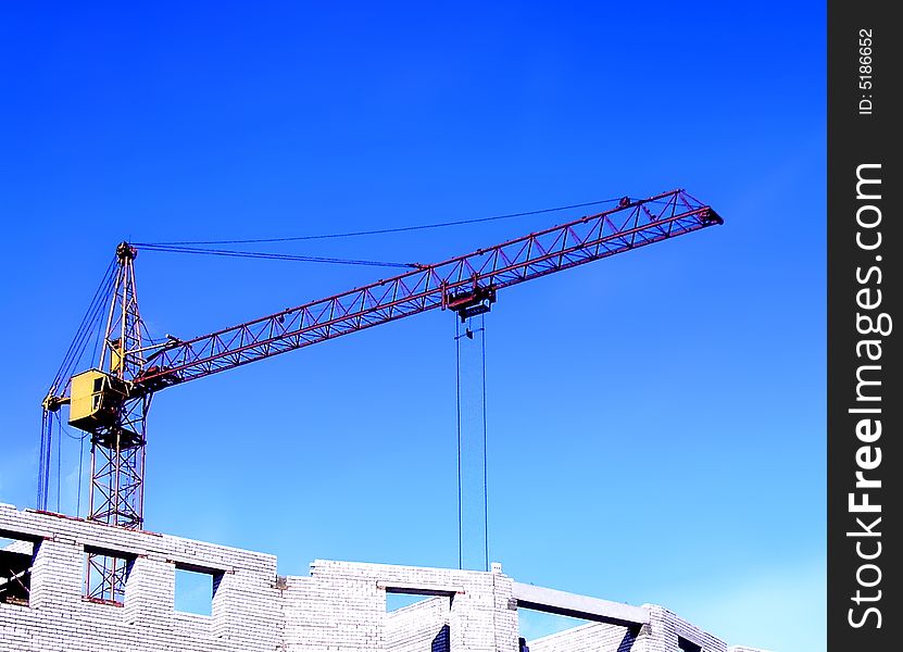 Construction of a new building by the hoisting crane. Construction of a new building by the hoisting crane.