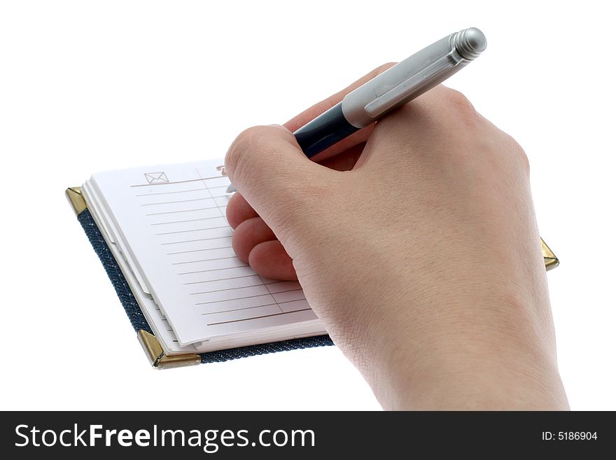The hand writes a ball pen in a notebook, on a white background. The hand writes a ball pen in a notebook, on a white background