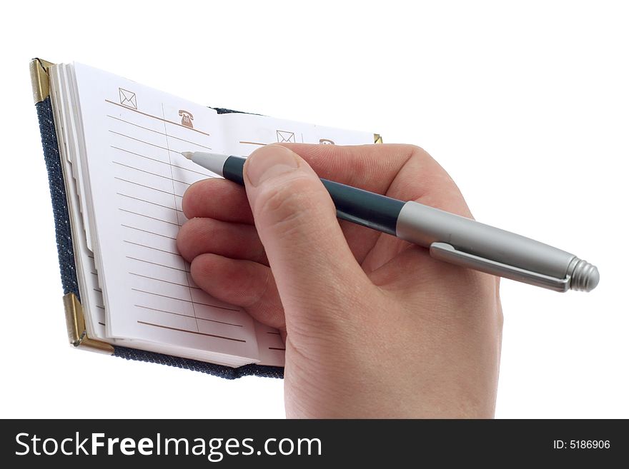 The hand writes a ball pen in a notebook, on a white background. The hand writes a ball pen in a notebook, on a white background