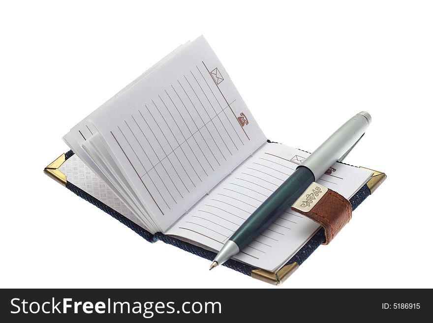 The opened notebook and ball pen on a white background