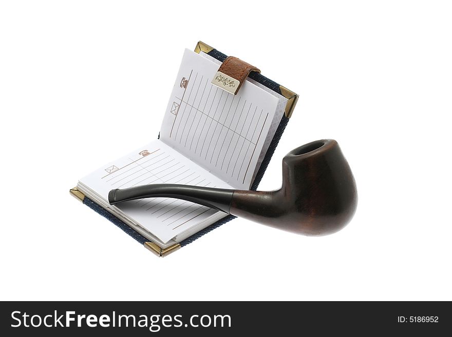 The opened notebook and pipe on a white background