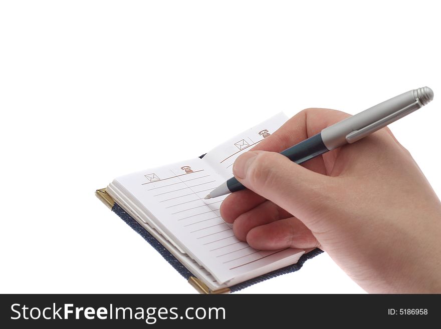 The hand writes a ball pen in a notebook, on a white background. The hand writes a ball pen in a notebook, on a white background