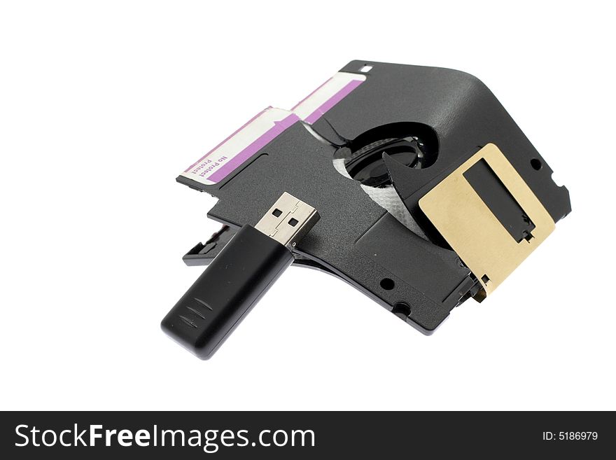 Broken old a diskette and USB flash on a white background. Broken old a diskette and USB flash on a white background