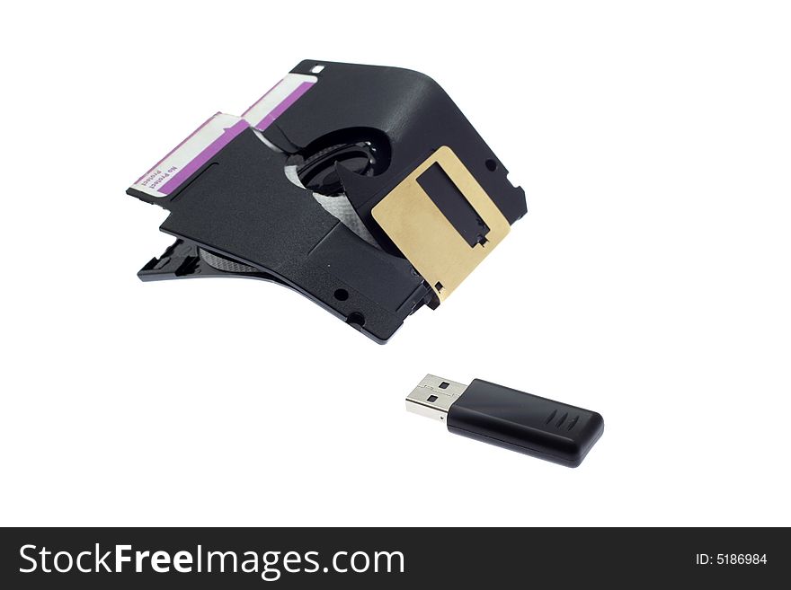 Broken old a diskette and USB flash on a white background. Broken old a diskette and USB flash on a white background