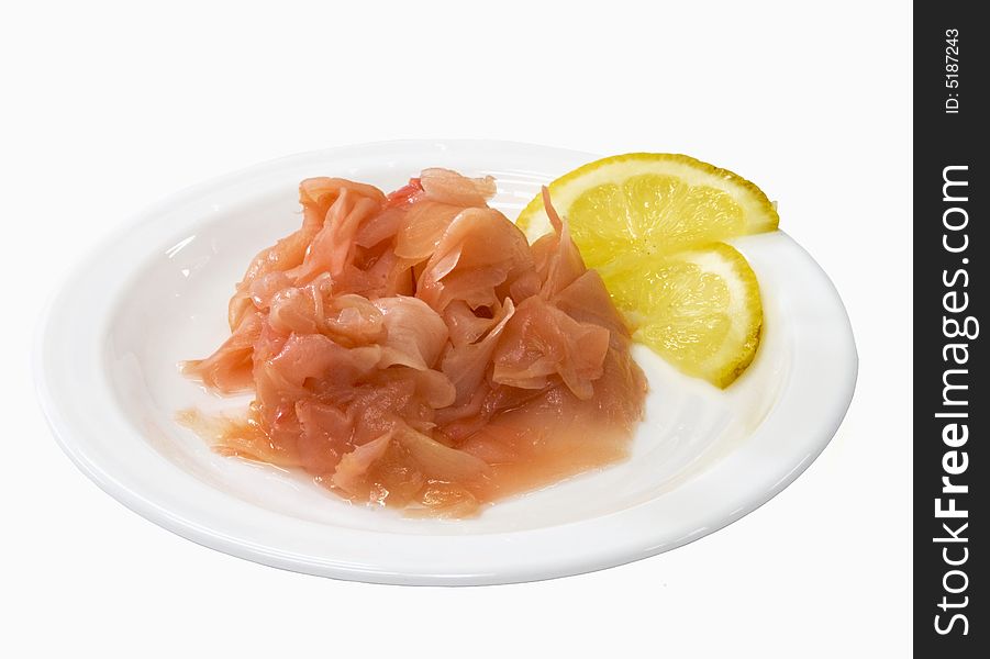 Ginger on the white plate with lemon isolated