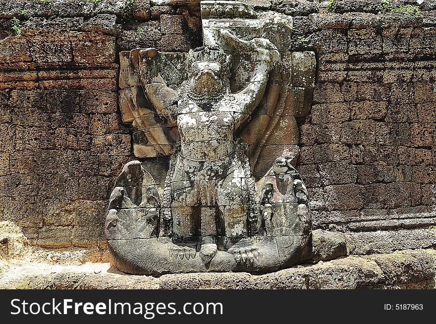 The Preah Khan temple was constructed in the style of bayon in the  late 12th century by the king Jayavarman VII; more than a temple it was probably a Buddhist university; the walls and pilliars are decorated with religious and mythological figures;  in this picture a giant garuda on the east wall. The Preah Khan temple was constructed in the style of bayon in the  late 12th century by the king Jayavarman VII; more than a temple it was probably a Buddhist university; the walls and pilliars are decorated with religious and mythological figures;  in this picture a giant garuda on the east wall