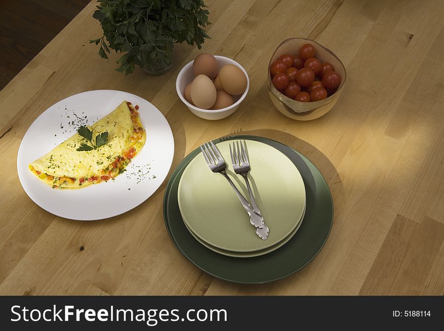 A streak of morning light falls accross a plate of a breakfast omelet. A streak of morning light falls accross a plate of a breakfast omelet.