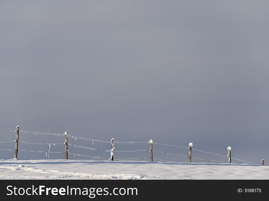 Winter landscape with snow and fence