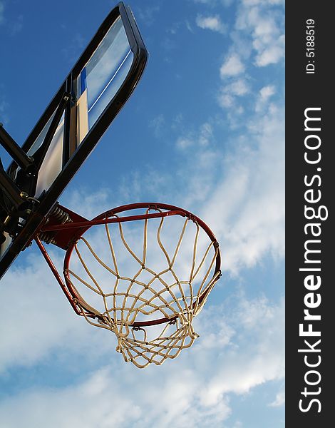 Basketball hoop against a blue sky. Sharp focus over entire image. Basketball hoop against a blue sky. Sharp focus over entire image.