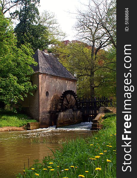 Romantic watermill with trees and flowers in spring. Romantic watermill with trees and flowers in spring