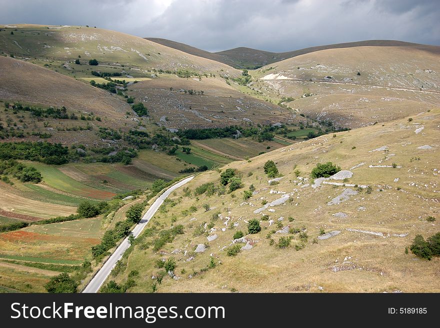 A mountain landscape with cloudy sky