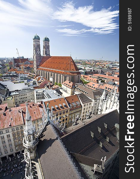 Munich's skyline featuring the Frauenkirche and local street cafes. Munich's skyline featuring the Frauenkirche and local street cafes