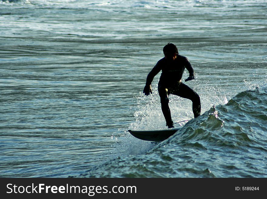 An image of a surfer doing a maneuver in the wave